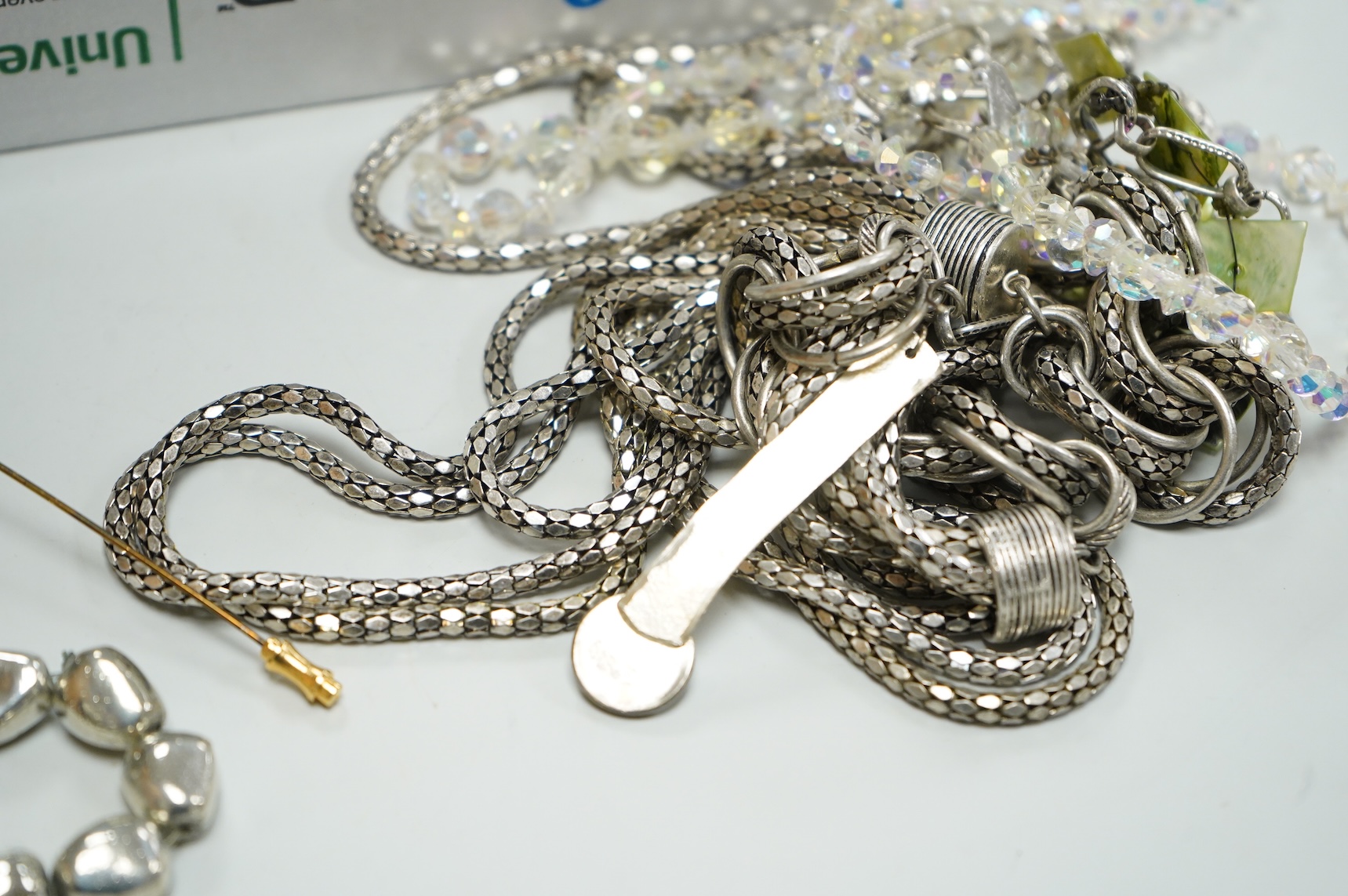 A collection of assorted costume jewellery, including a pair of spherical amethyst drop earrings, a modern silver mounted aide memoire, brooches, necklaces, rings et.